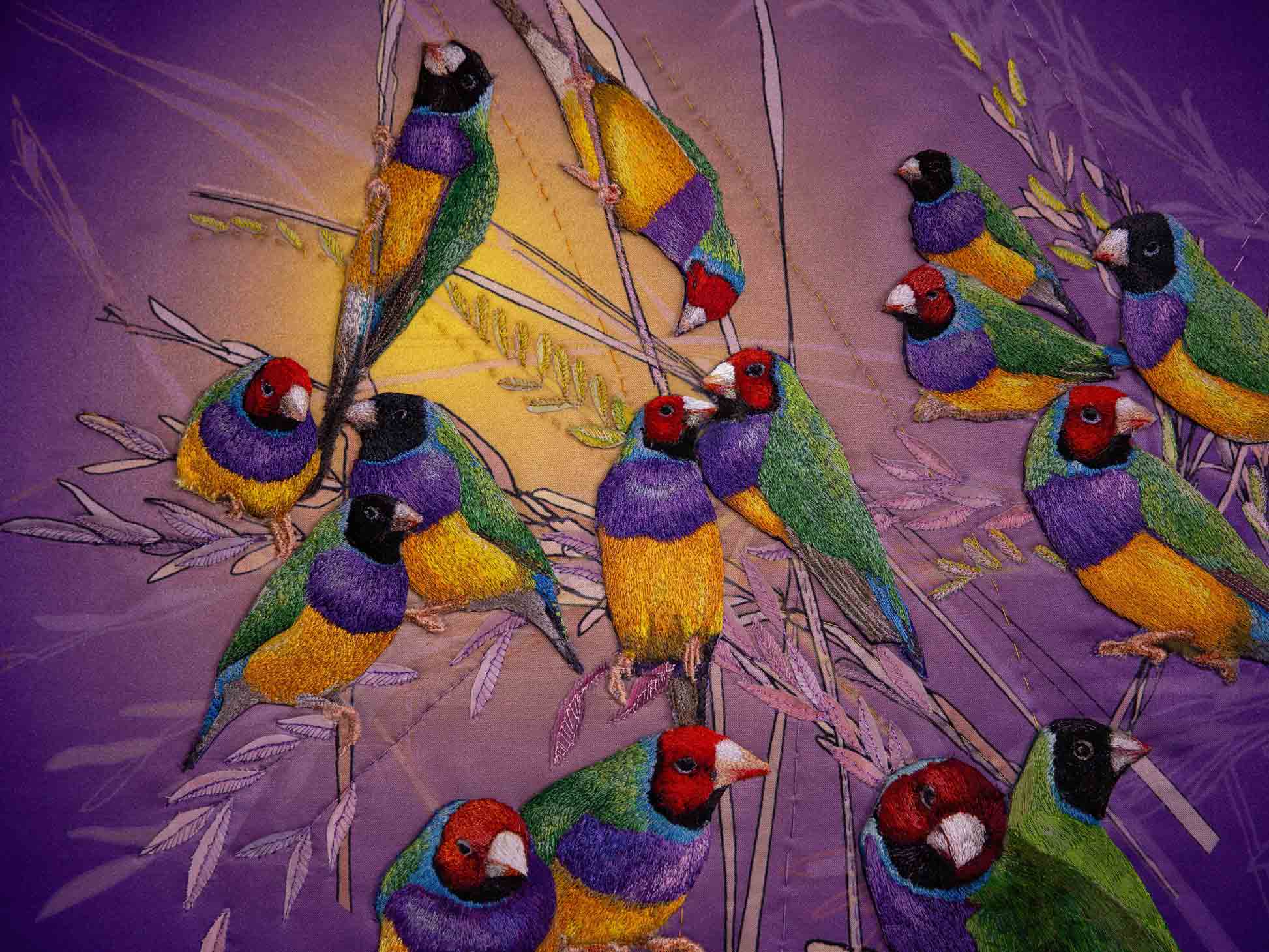 textural details of birds appliqued onto flat grass appliqued background